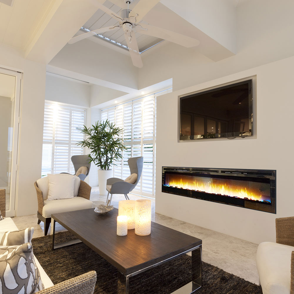 Linear electric fireplace in wall with glowing LED flame strip and black trim