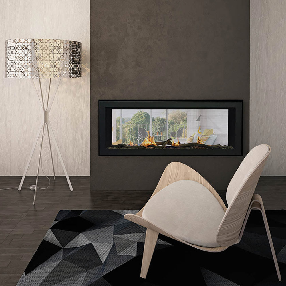 Linear see-through gas fireplace with black surround, glowing flames, and seating