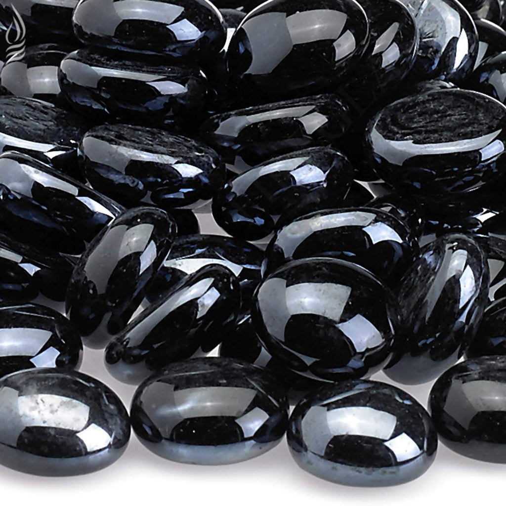 Fire glass beads close-up, dark oval pieces with bright reflective sheen