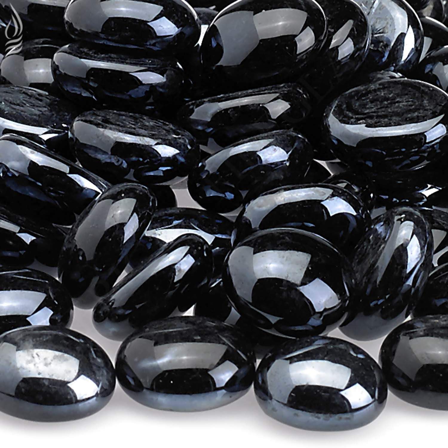 Fire glass beads close-up, dark oval pieces with bright reflective sheen
