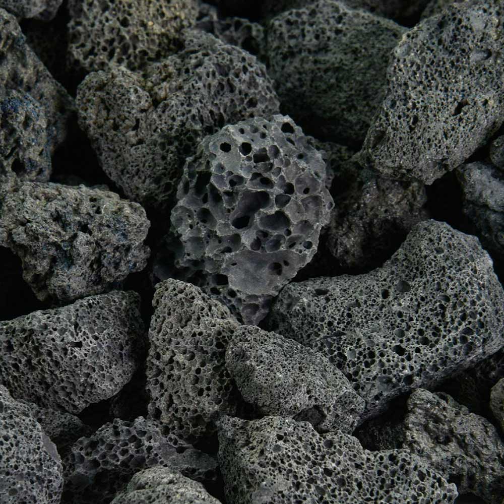 Volcanic stone fireplace media, dark gray porous lava rocks with holes