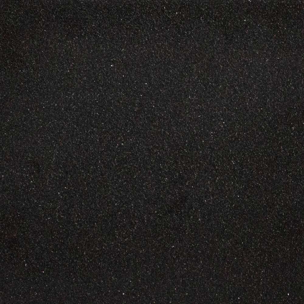 Black granite stone texture close-up, fine speckles and mottled surface