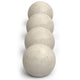 Stack of light beige fire pit spheres with speckled finish