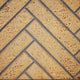Sandstone decorative fireplace panel with herringbone pattern and dark trim