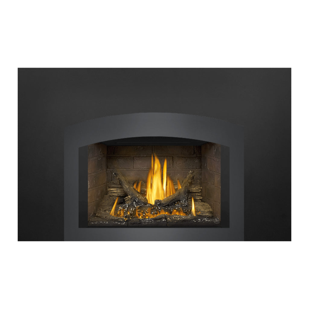 Direct vent gas fireplace insert showing lit burner with tall flames and log set inside.