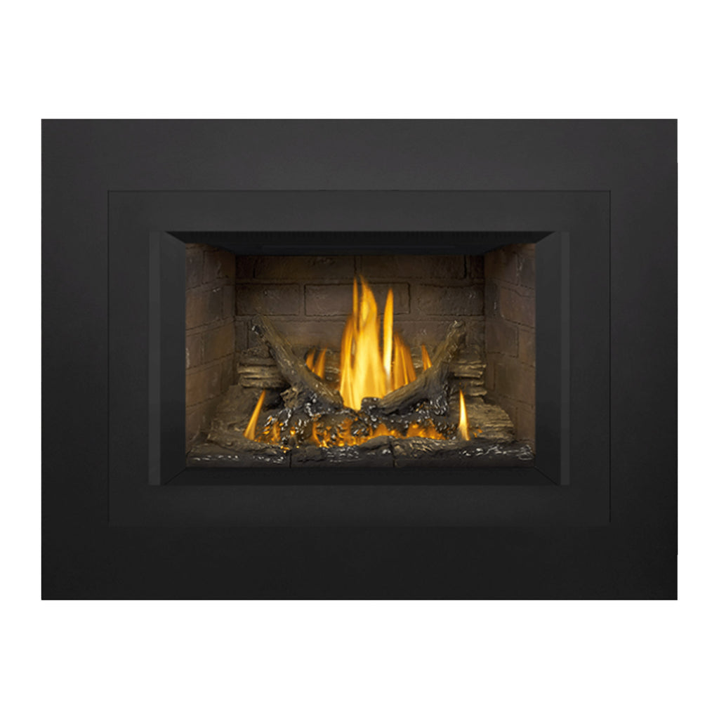 Direct vent gas fireplace insert with tall flames in a stone surround opening