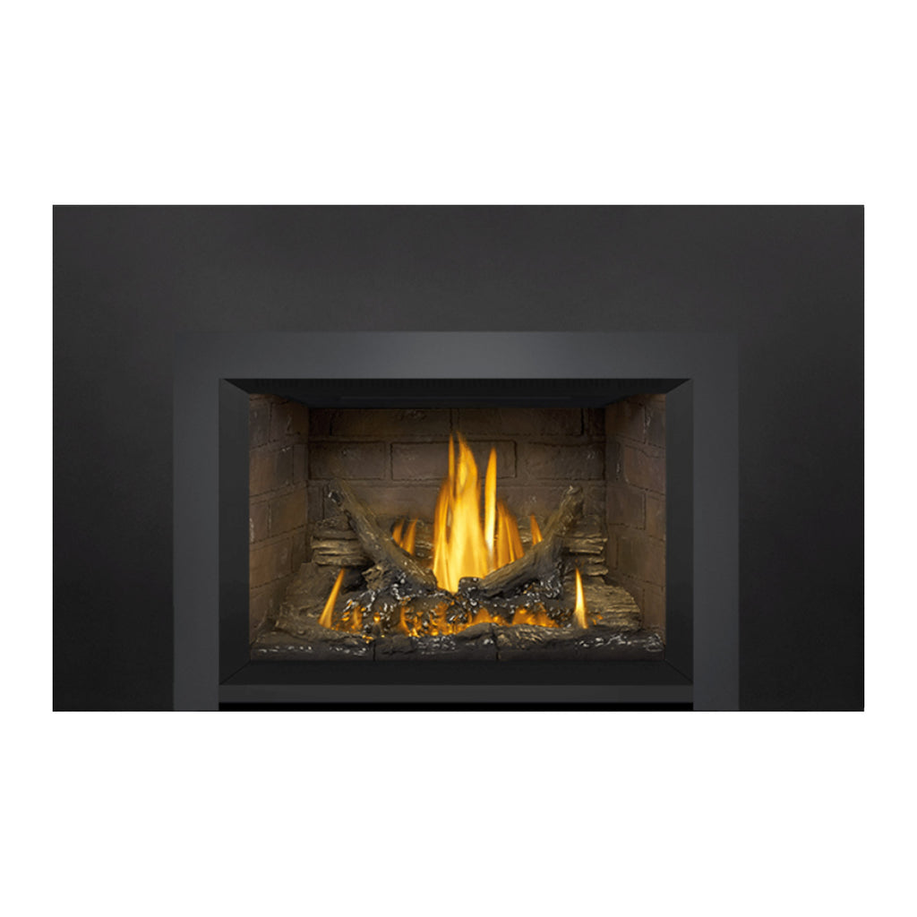 Gas fireplace insert featuring a stone firebox with burning logs and dark rectangular frame
