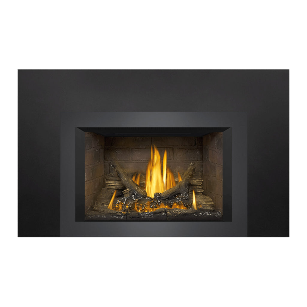 Gas fireplace insert with dark outer trim, stone back panel, burning logs and embers