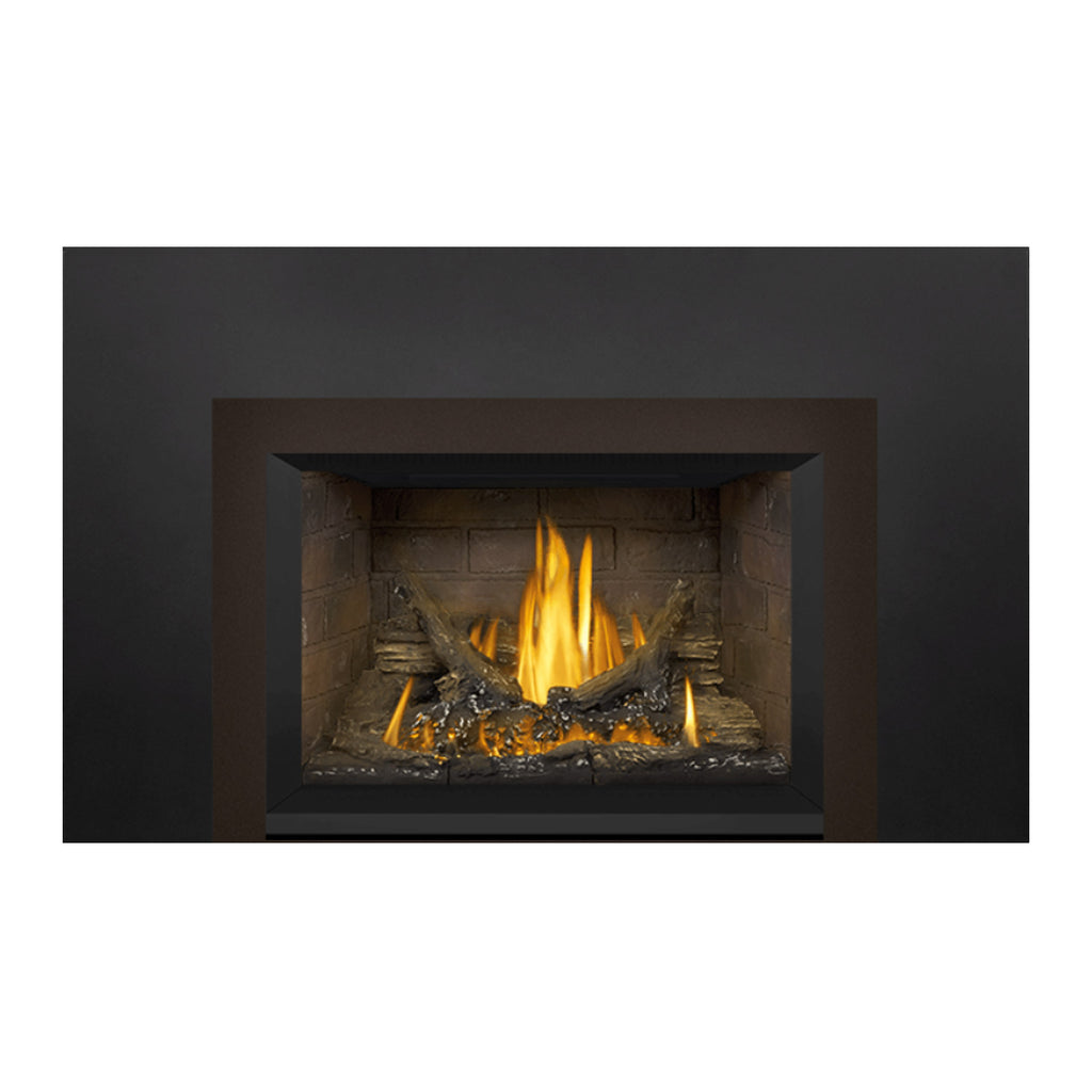 Gas fireplace insert with tan stone firebox and flames glowing behind the glass opening