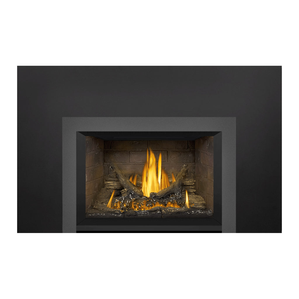 Direct vent gas fireplace insert with dark surround and burning logs in stone firebox