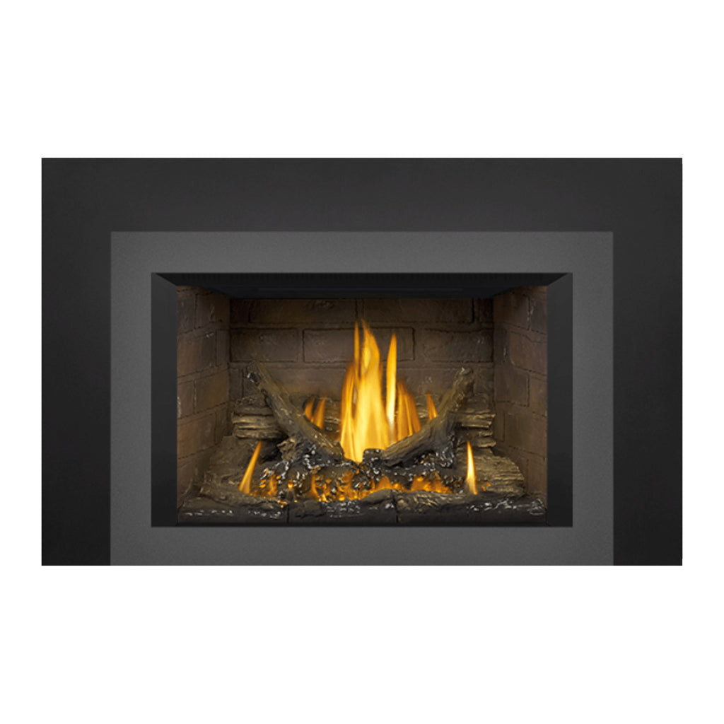 Gas fireplace insert with dark outer frame and stone back, burning logs and bright flames