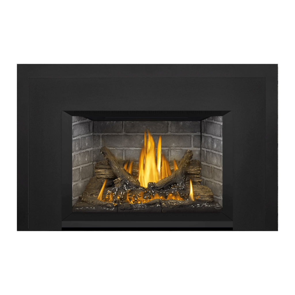 Direct vent gas fireplace insert with dark surround, stone back, and lit logs with active flames