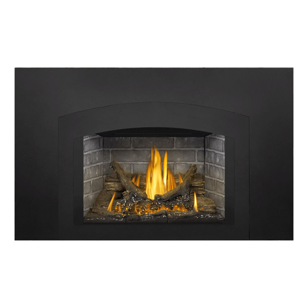 Gas fireplace insert with black surround and arched panel, flames, faux logs, gray brick.