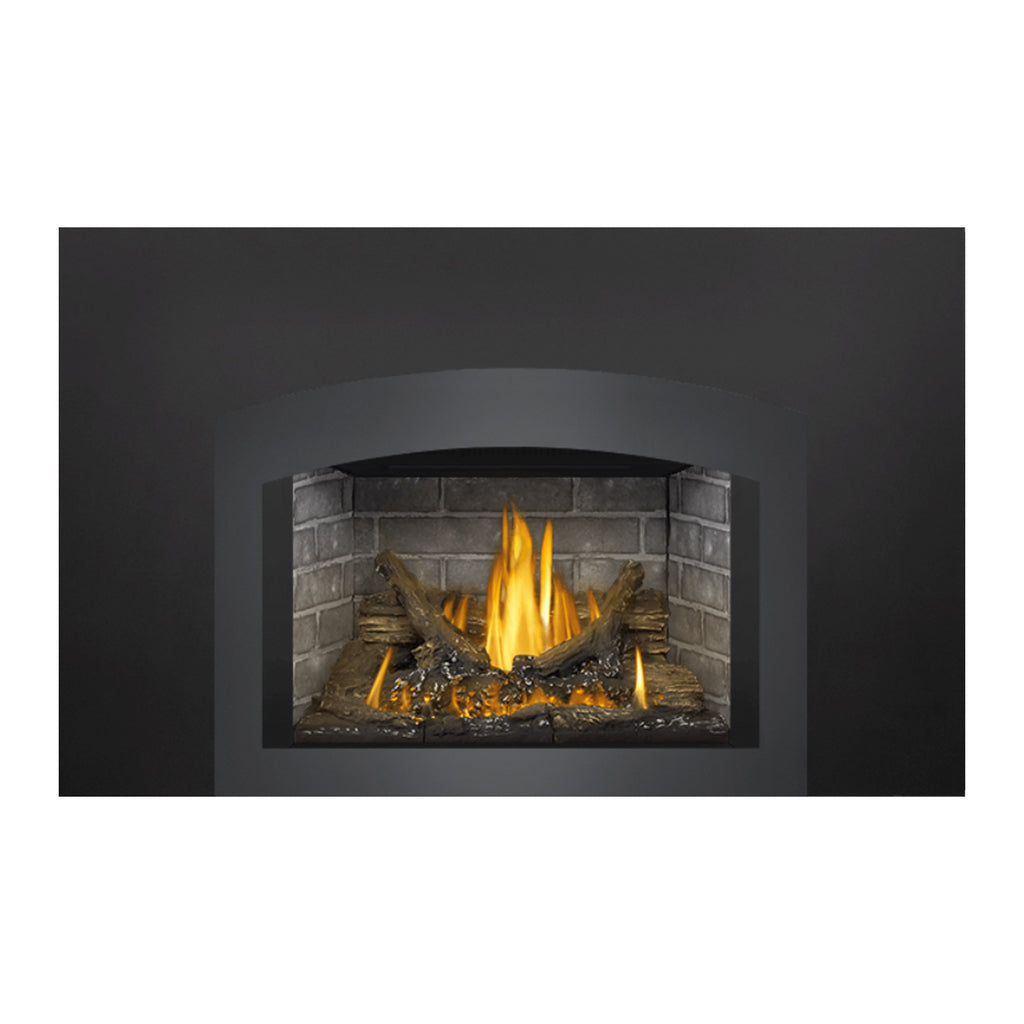 Gas fireplace insert with dark frame and steady yellow flames in stone