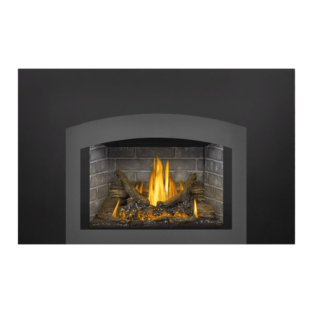 Gas fireplace insert with dark surround and bright flames in a stone interior