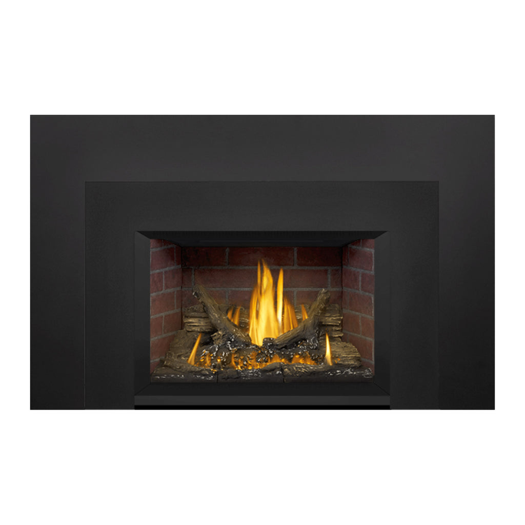 Direct vent gas fireplace insert with black frame, brick firebox, burning flame, and log set