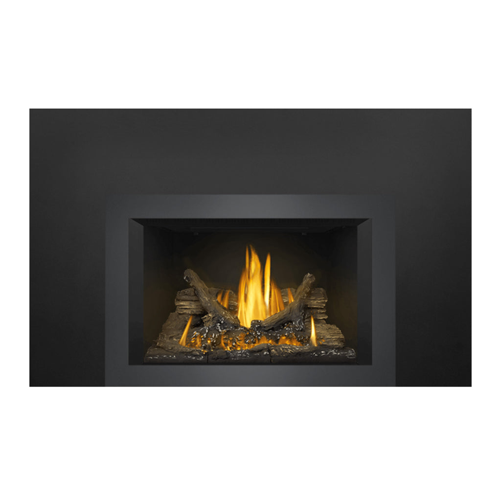 Direct vent gas fireplace insert firebox with glowing yellow flames and dark logs