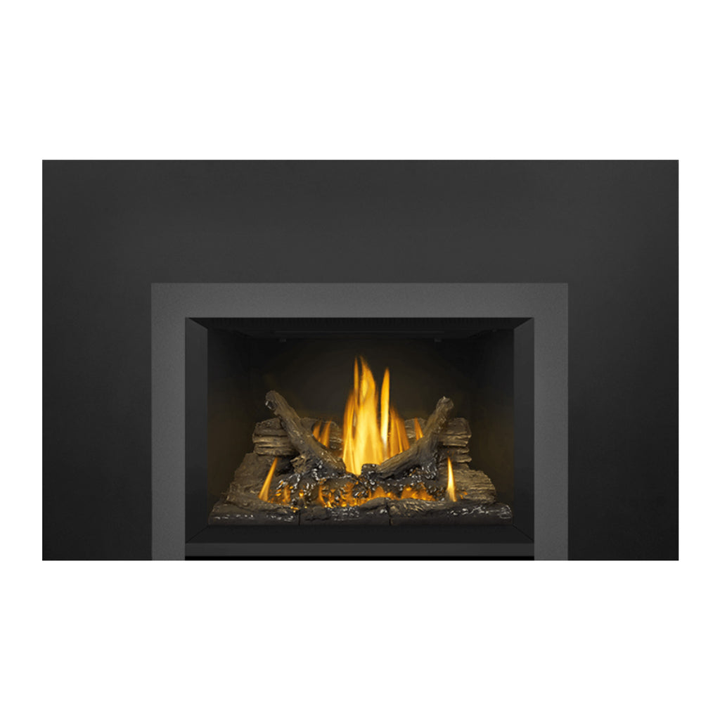 Gas fireplace insert showing tall flames over dark logs and ember bed within the frame