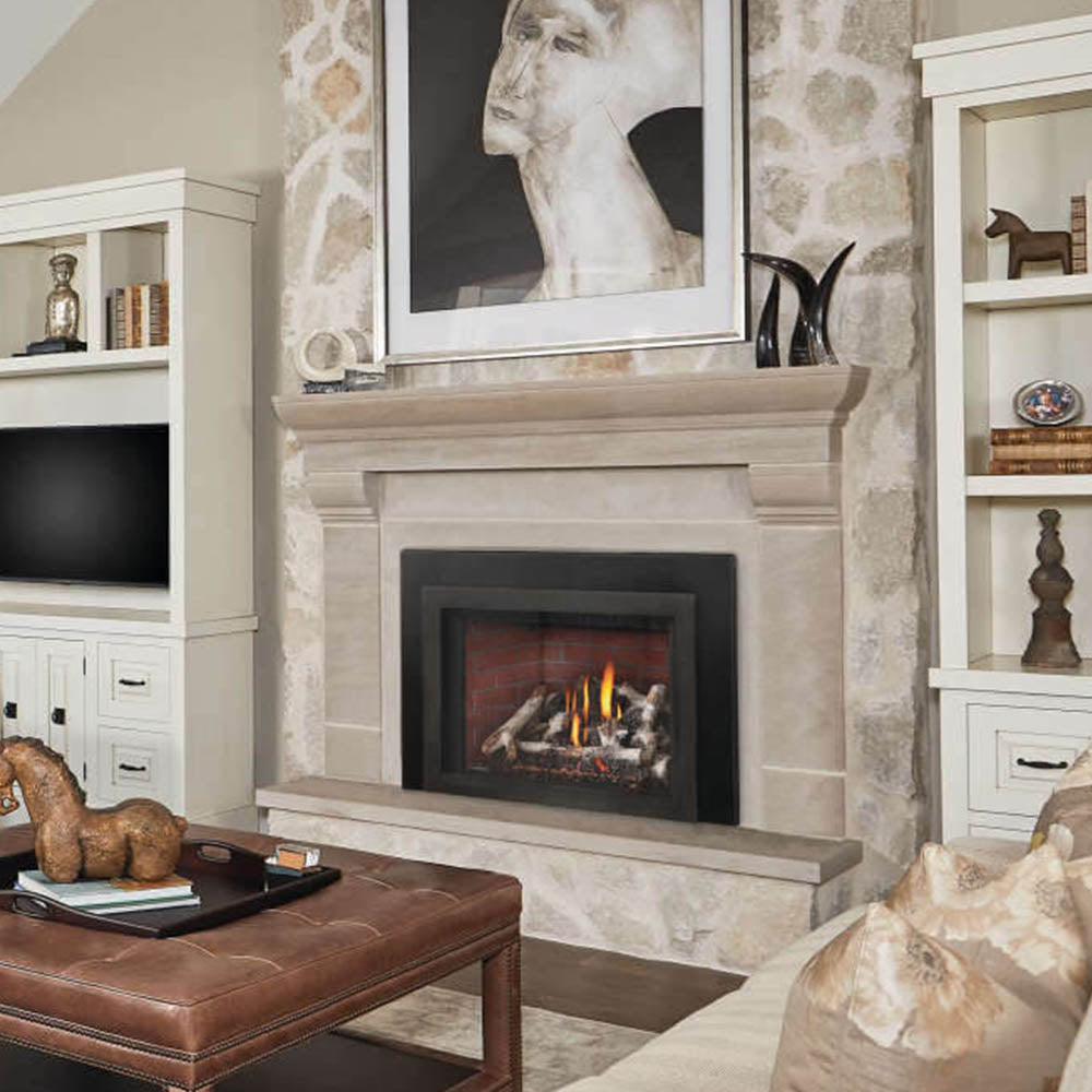 Direct vent gas fireplace insert in stone surround with burning logs