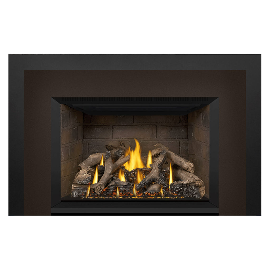 Gas fireplace insert showing burning logs in stone firebox with black surround framing.