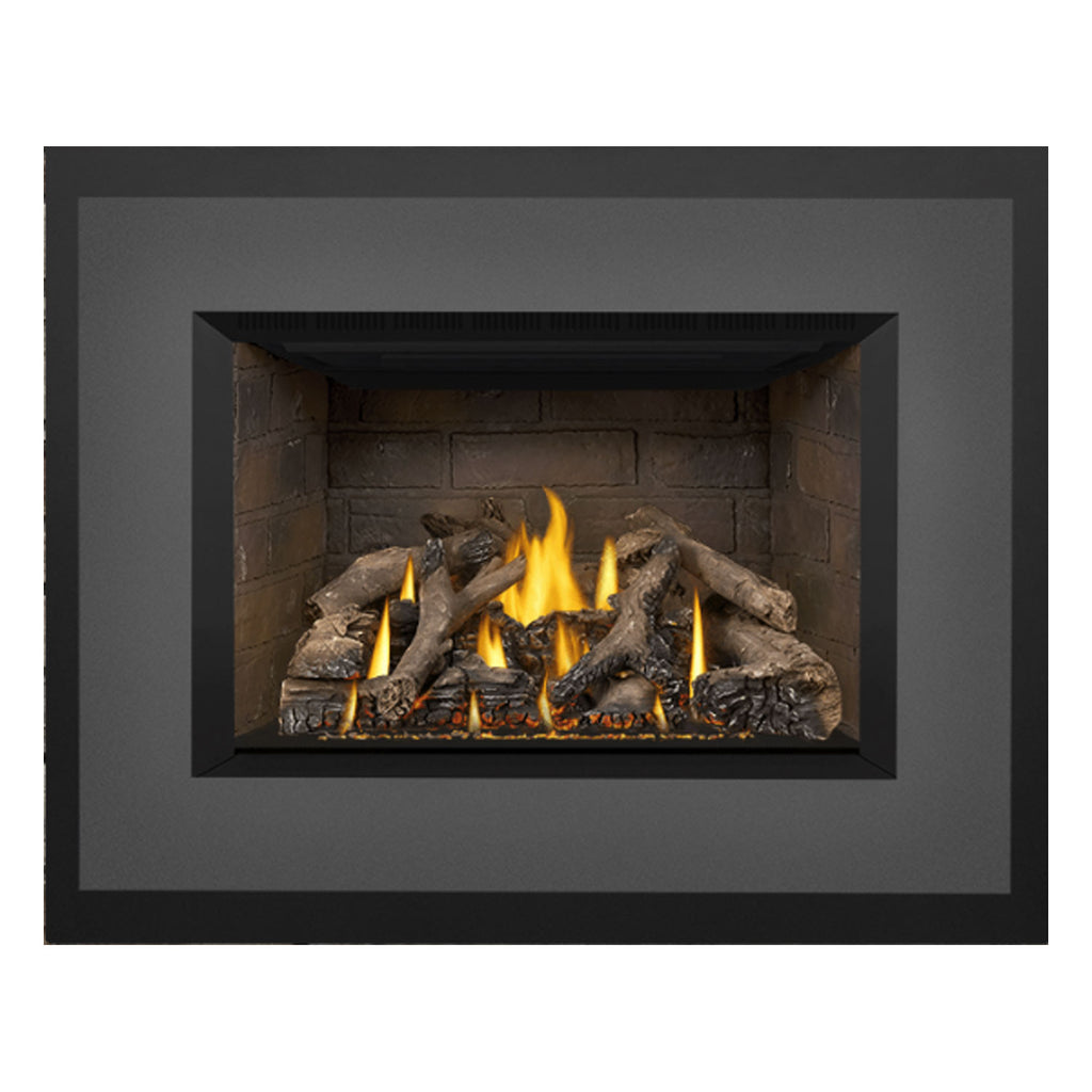 Gas fireplace insert with burning logs in stone firebox and black surround border.
