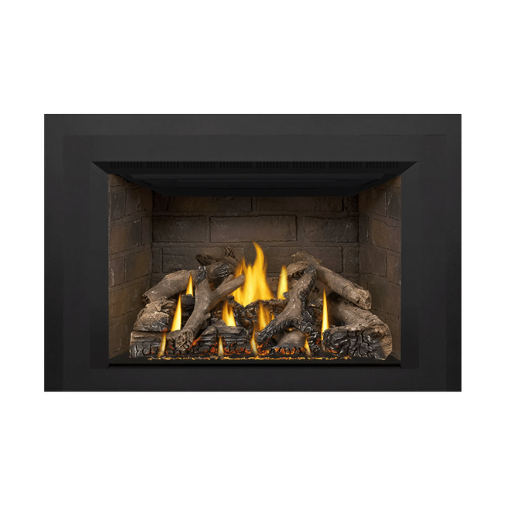 Gas fireplace insert firebox with burning flames and decorative logs along the base