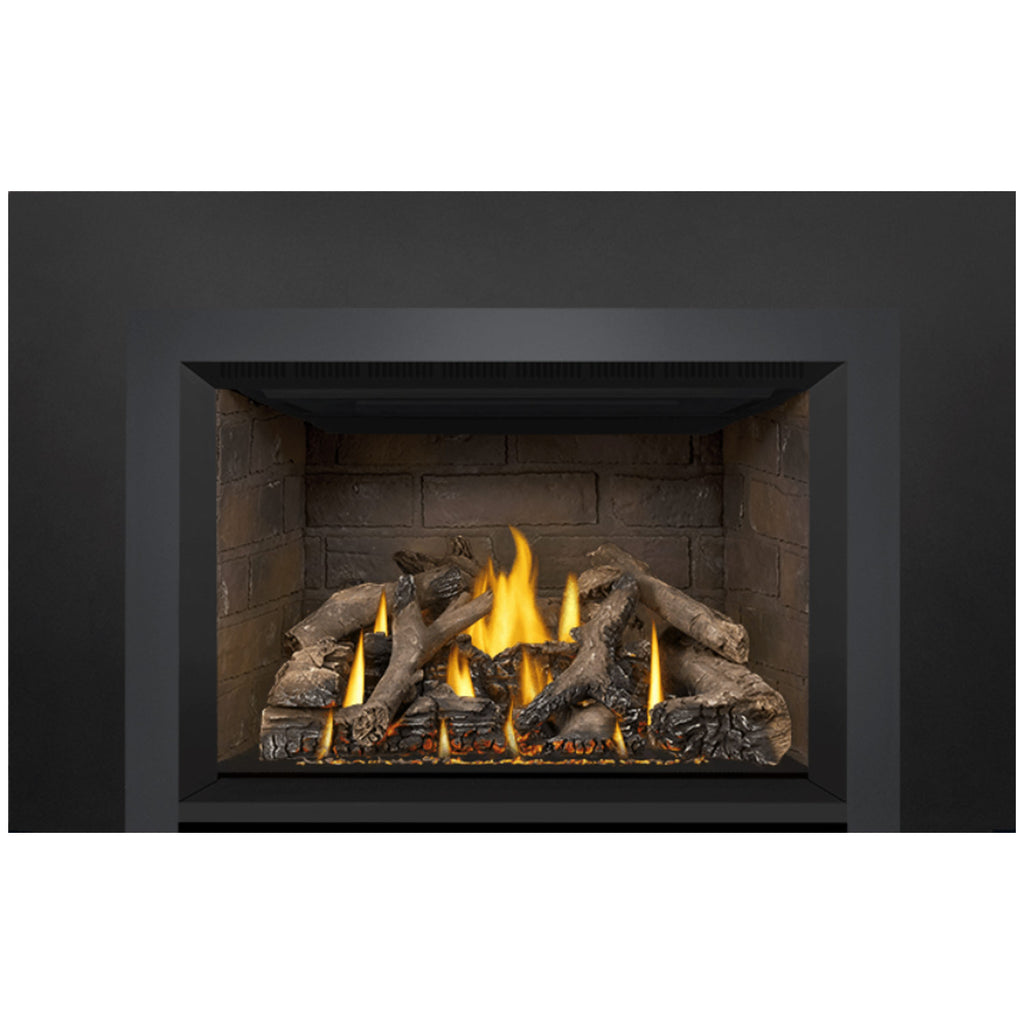 Gas fireplace insert with glowing flames and dark log pieces in a rectangular opening