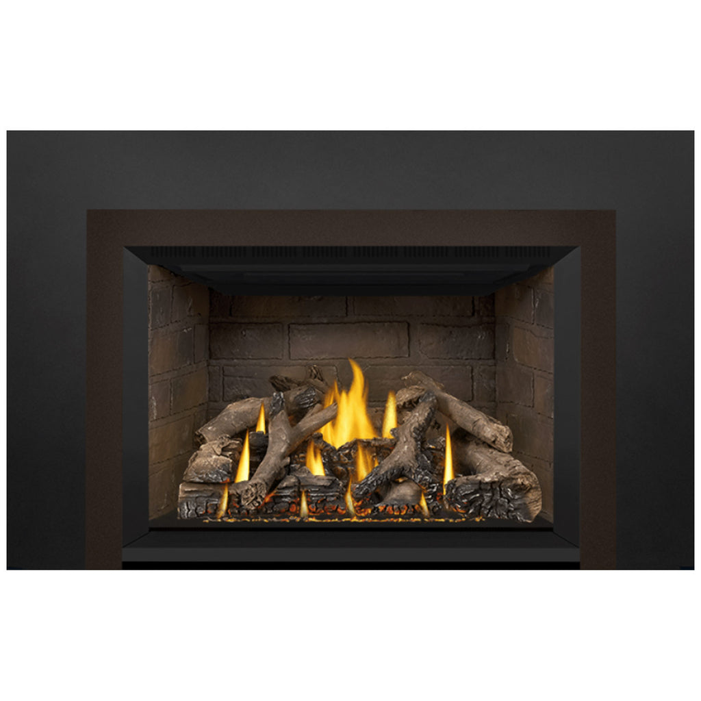Gas fireplace insert showing glowing flames among dark decorative logs in the firebox