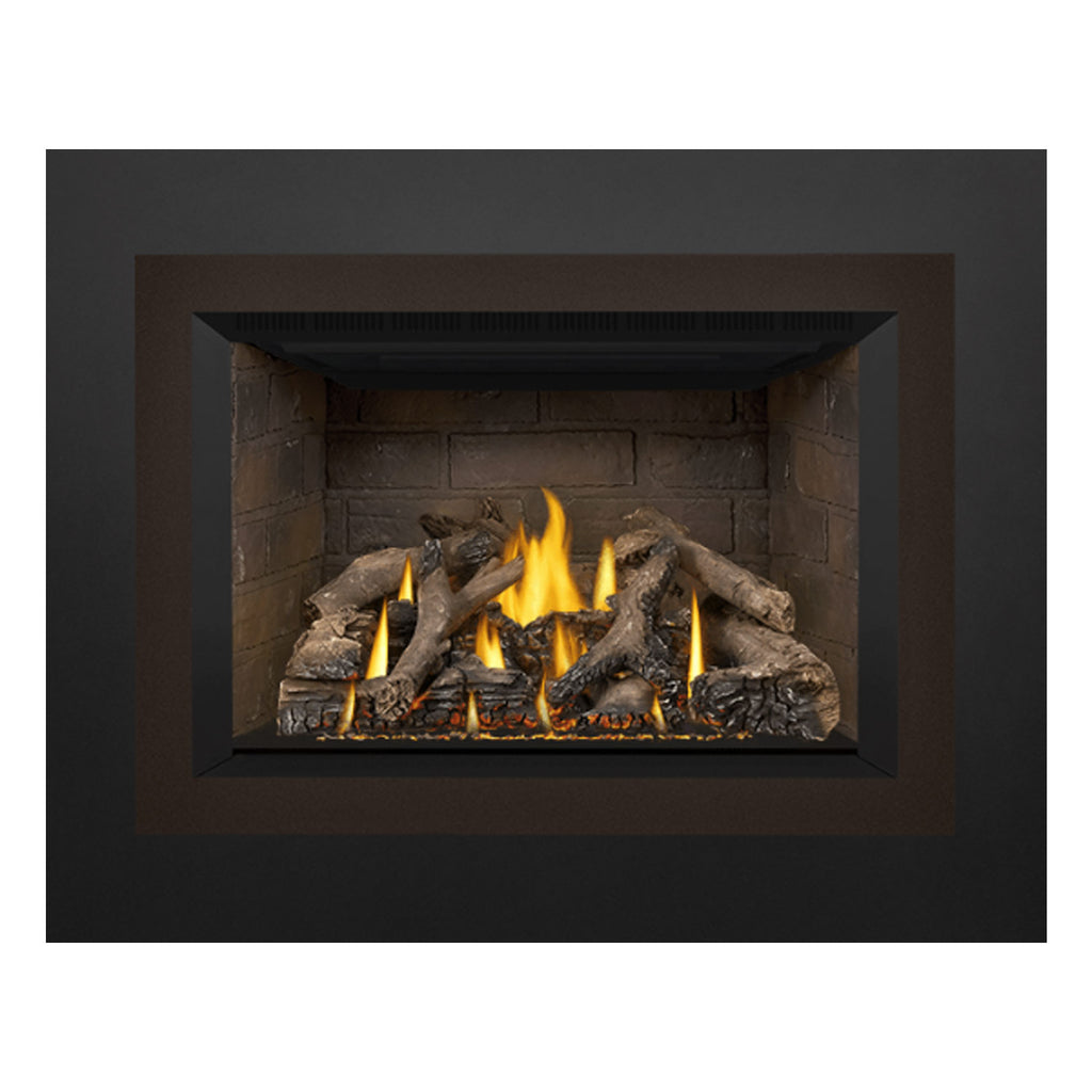 Direct vent gas fireplace insert framed in dark metal with stone firebox and burning logs.