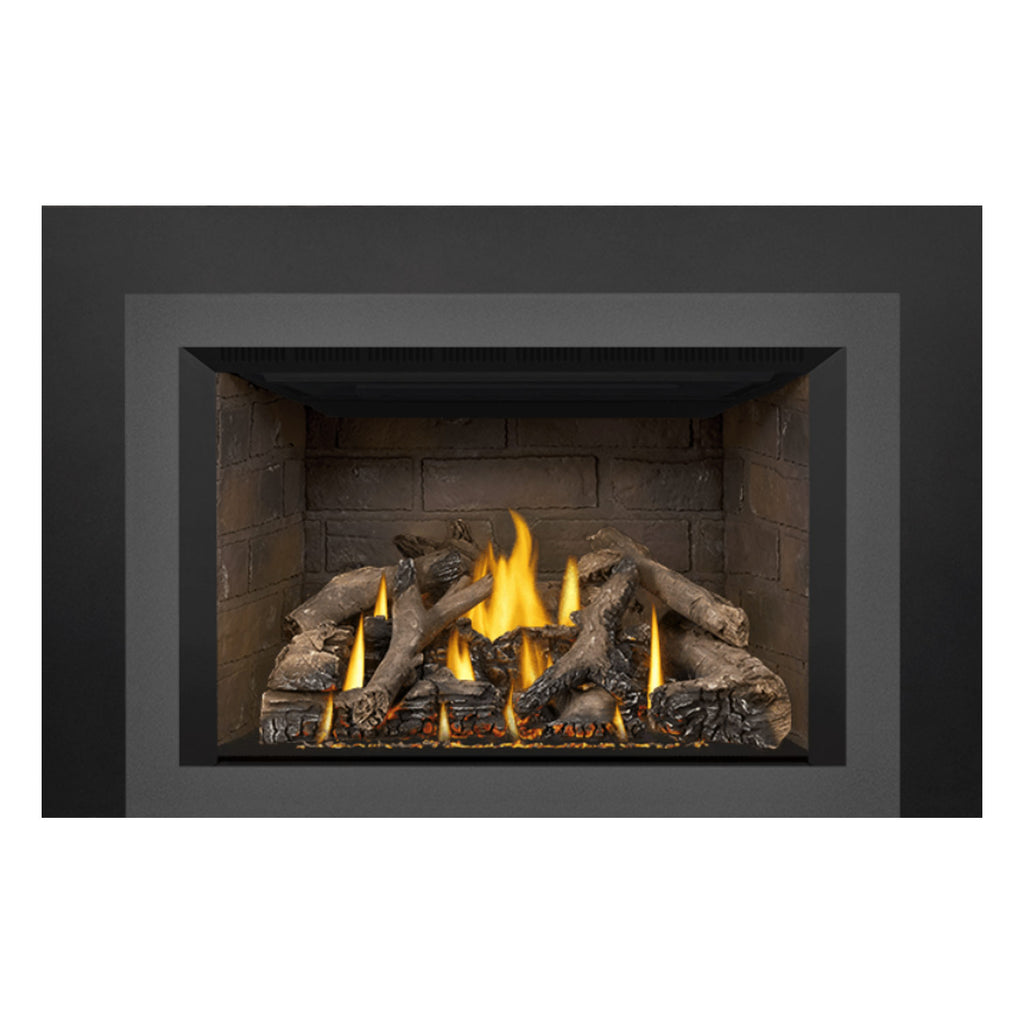 Direct vent gas fireplace insert with dark frame and stone interior, burning flames on logs.