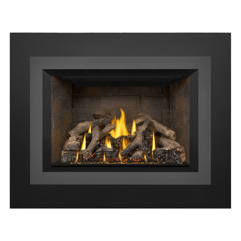Direct vent gas fireplace insert with stone firebox, burning flames, and stacked logs.