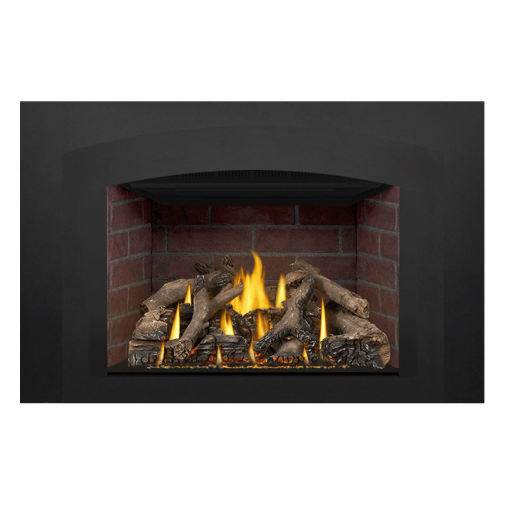 Direct-vent gas fireplace insert with burning logs, yellow flames, and red brick back panel