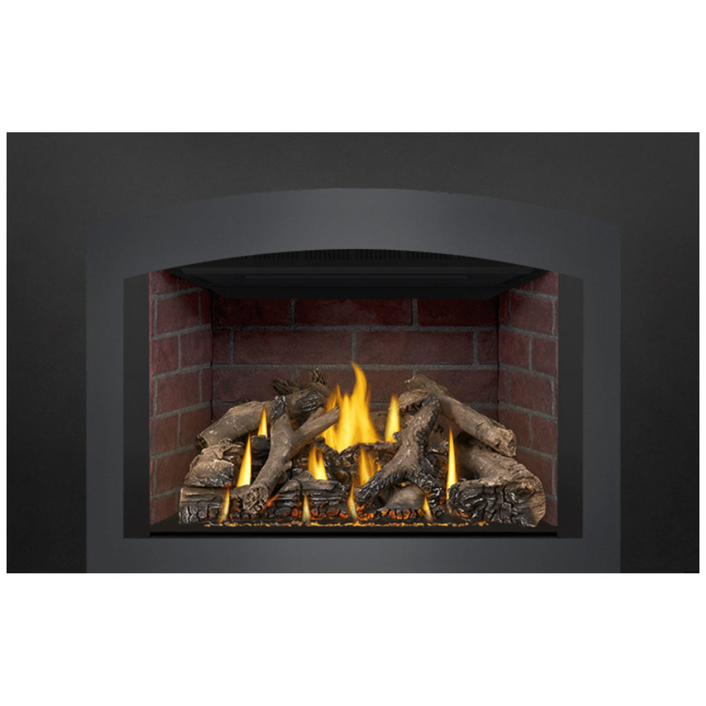 Direct vent gas fireplace insert, burning flames and log set visible in brick cavity