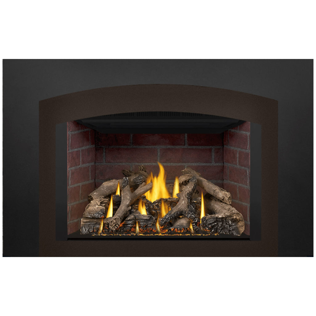 Direct vent gas fireplace insert with flames, gas burner, and log set against brick