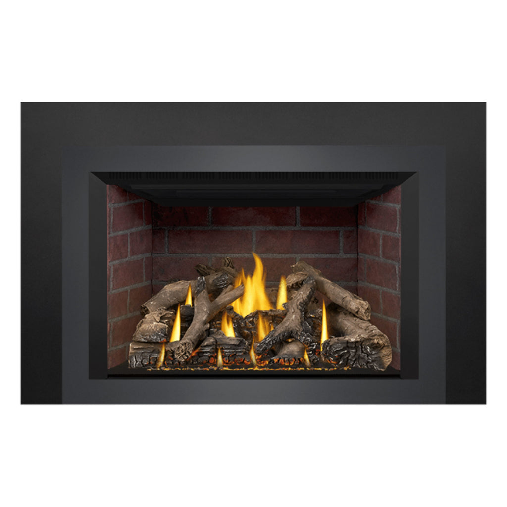 Direct-vent gas fireplace insert with lit logs, bright flames, and red brick firebox interior