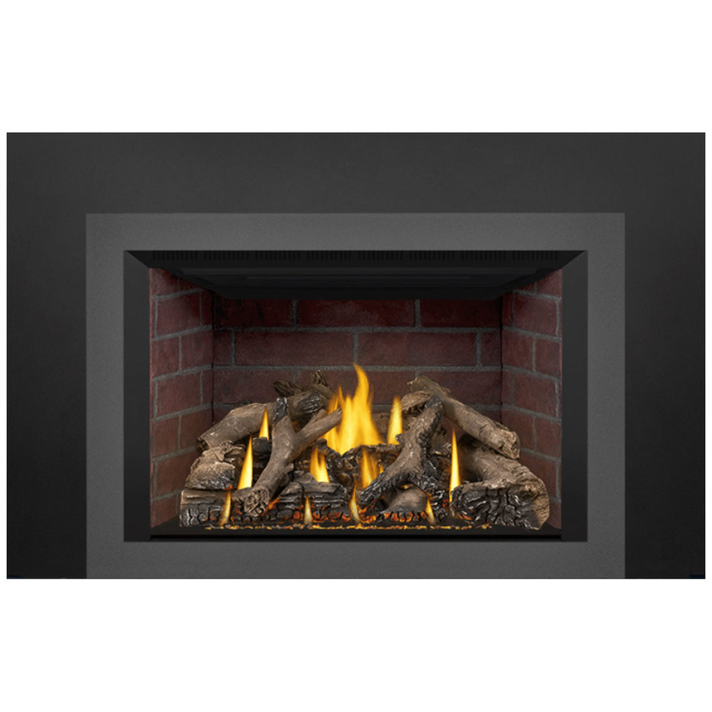 Direct-vent gas fireplace insert showing glowing logs and yellow-orange flames in red brick