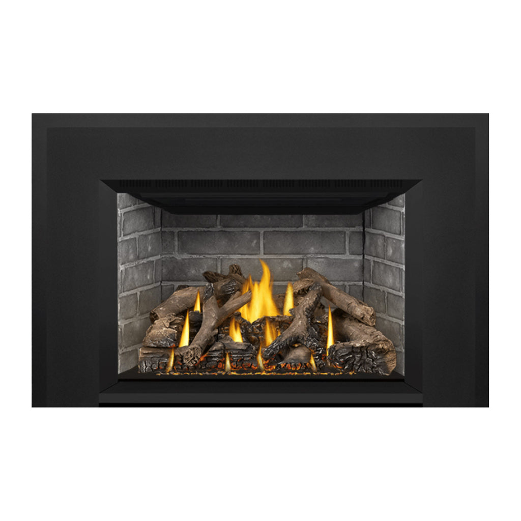 Gas fireplace insert recessed view with burning flames, gray brick back, and logs