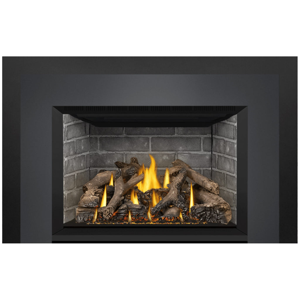Direct vent gas fireplace insert with dark surround and stone firebox; burning log set