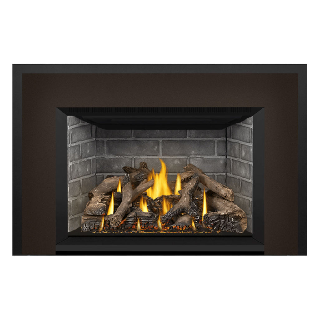 Gas fireplace insert view with burning flames, gray brick lining, and dark logs