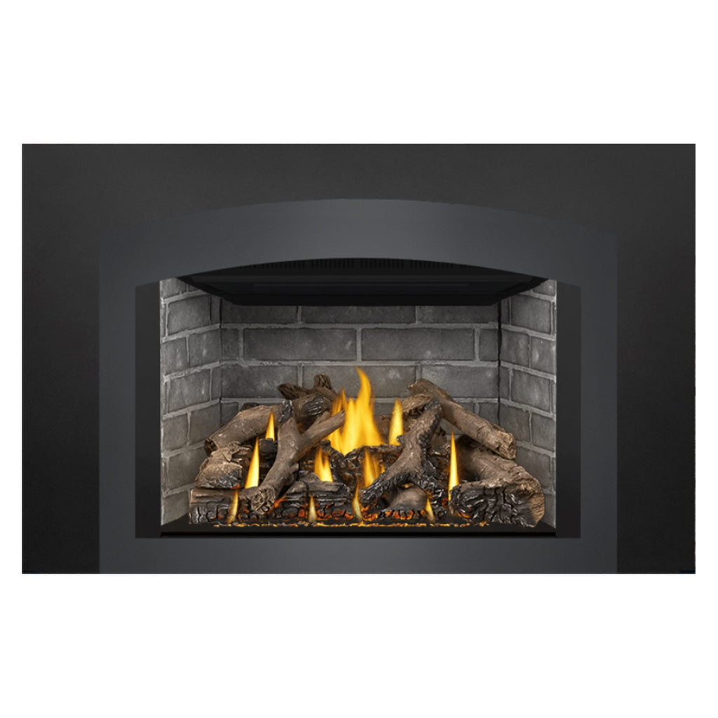 Gas fireplace insert with burning flames and dark logs in gray brick enclosure