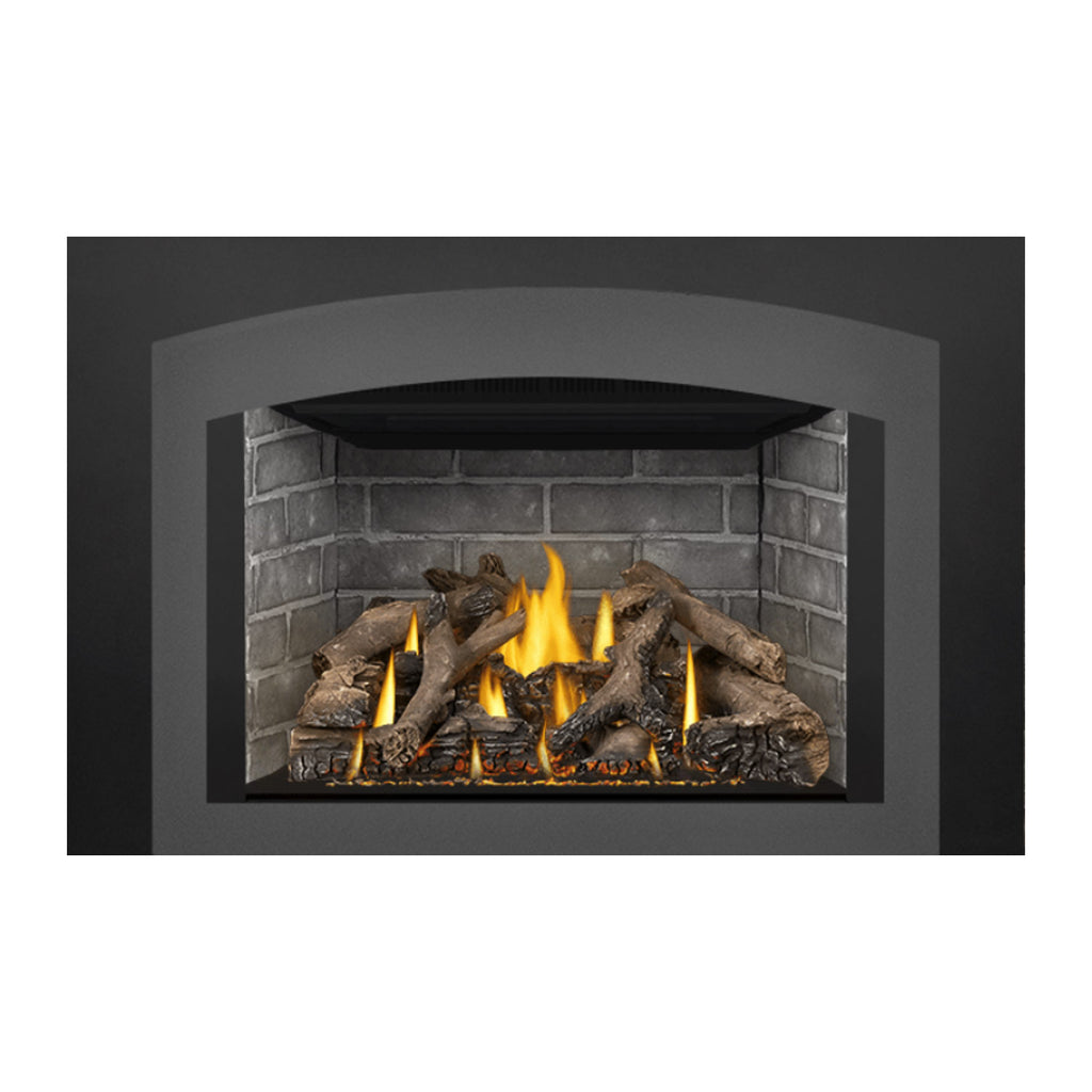 Gas fireplace insert with burning flames, gray brick lining, and dark log pieces
