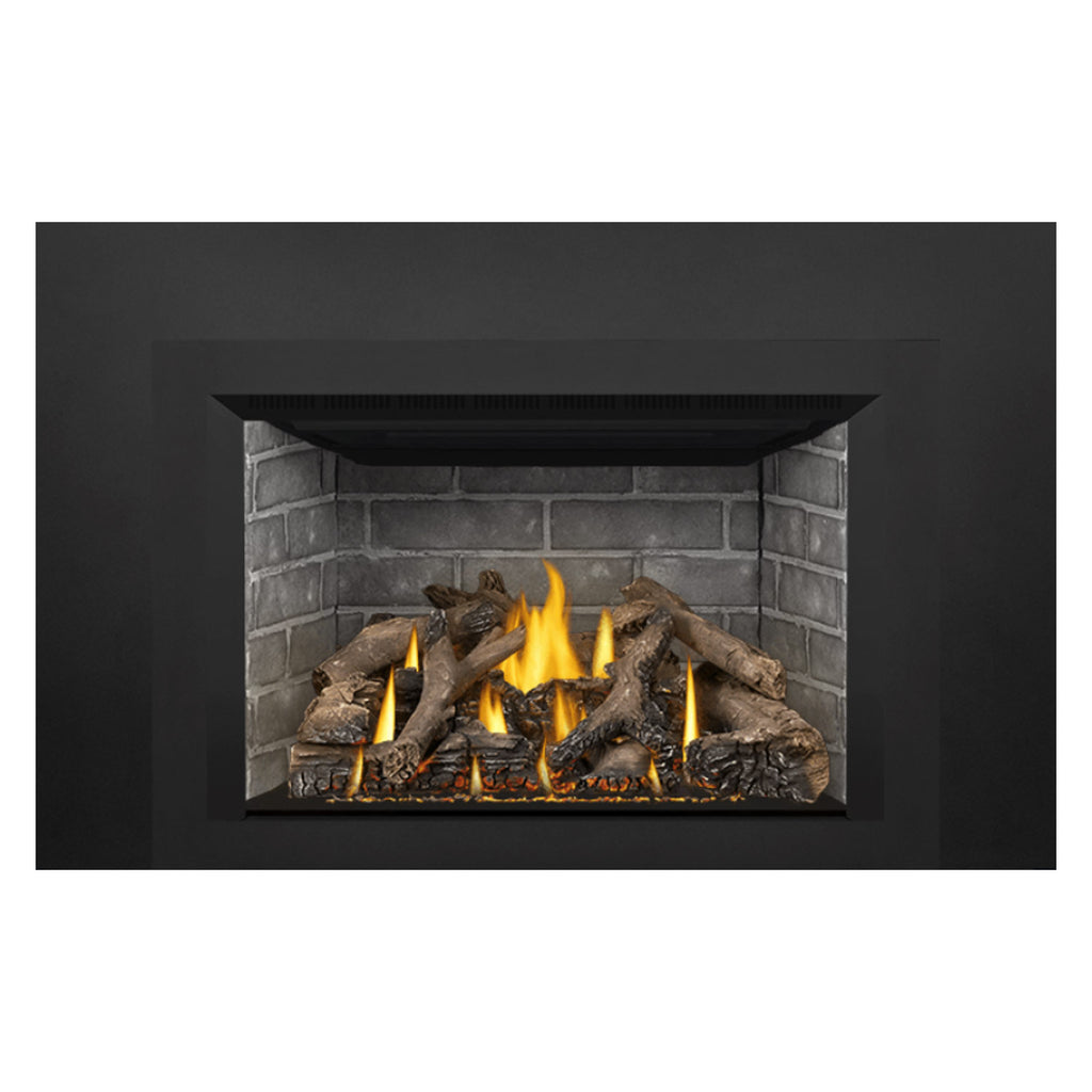 Direct vent gas fireplace insert with steady flames and charred logs over embers