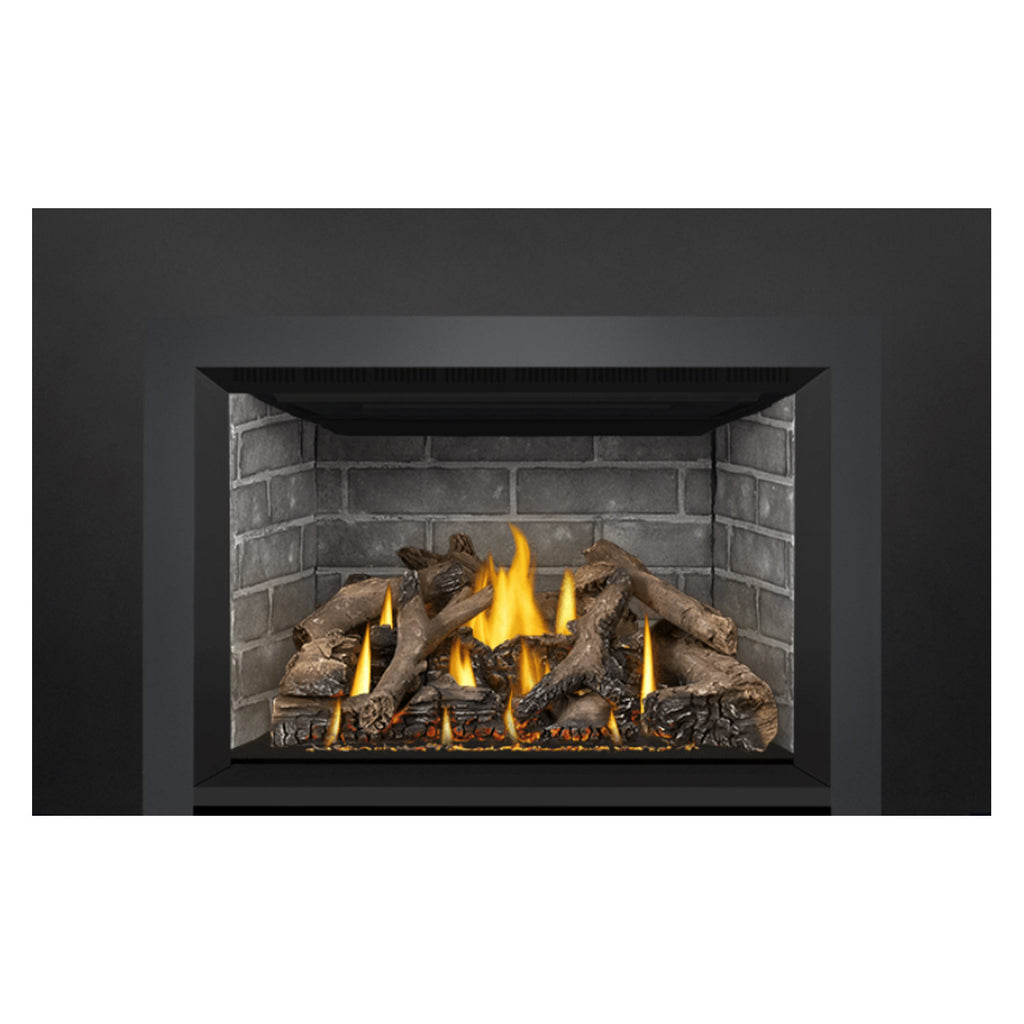 Direct vent gas fireplace insert with burning flames in a brick-lined firebox