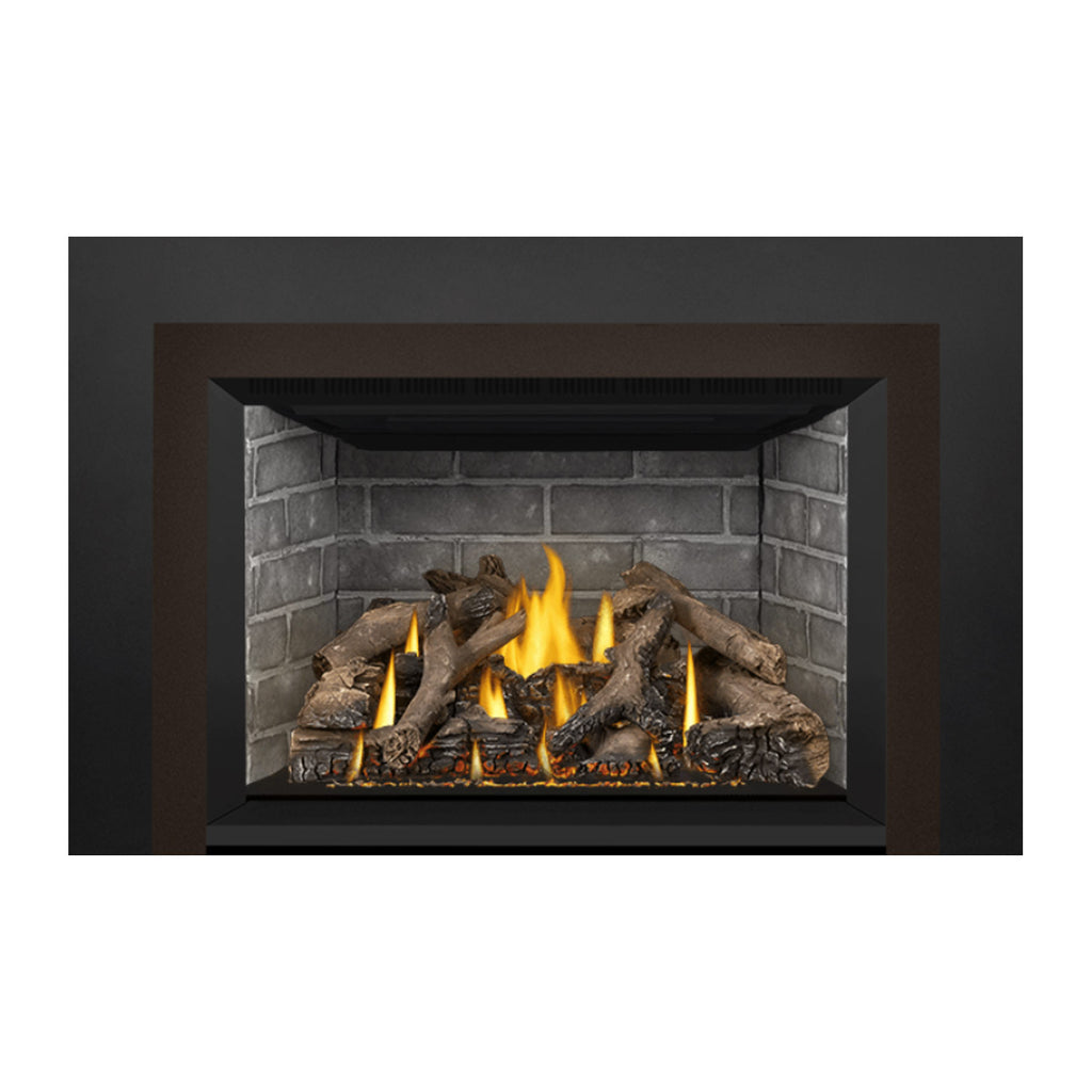 Direct vent gas fireplace insert showing burning flames and stacked log bed