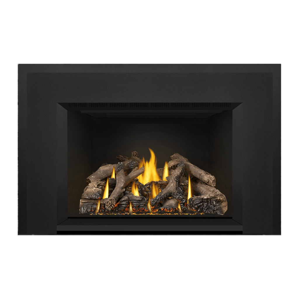 Gas fireplace insert with a deep black firebox, burning logs, and yellow flames
