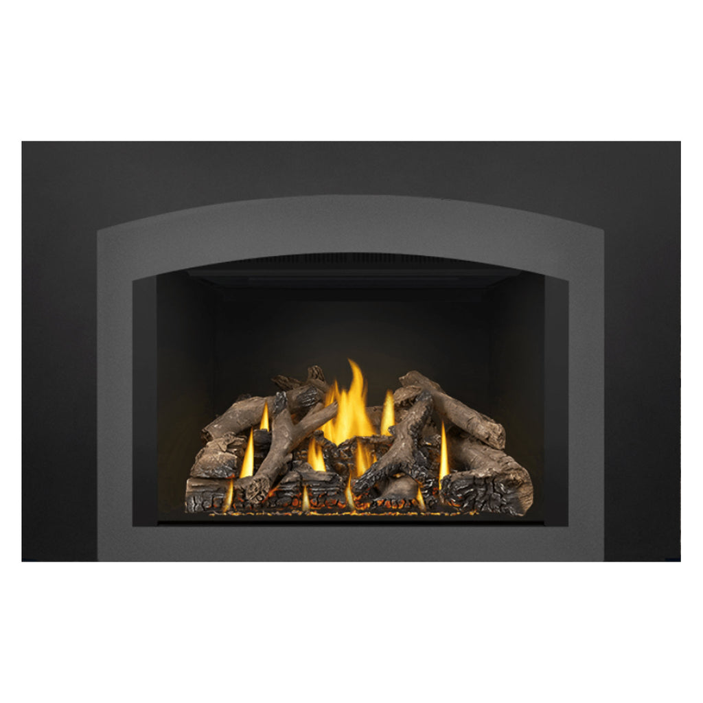 Gas fireplace insert with burning logs and yellow flames under a black vent hood