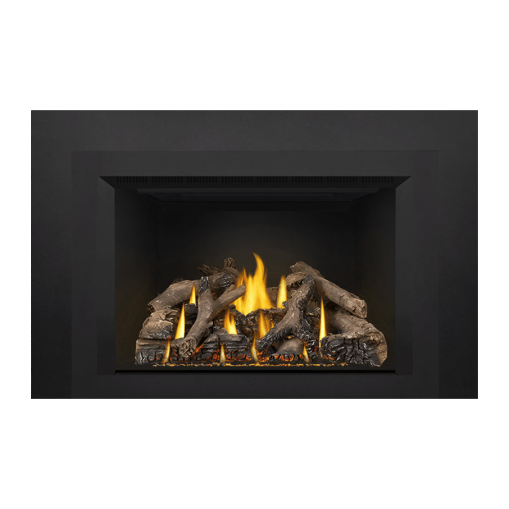 Black direct vent gas fireplace insert with burning flames and gray logs across the burner.