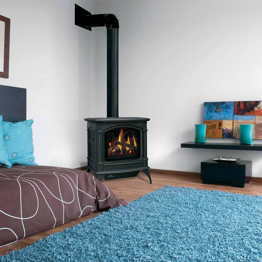 Black direct-vent cast iron gas stove with chimney pipe and burning log firebox