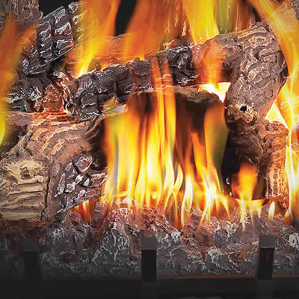 Vented gas log set close view of burning flames over textured logs