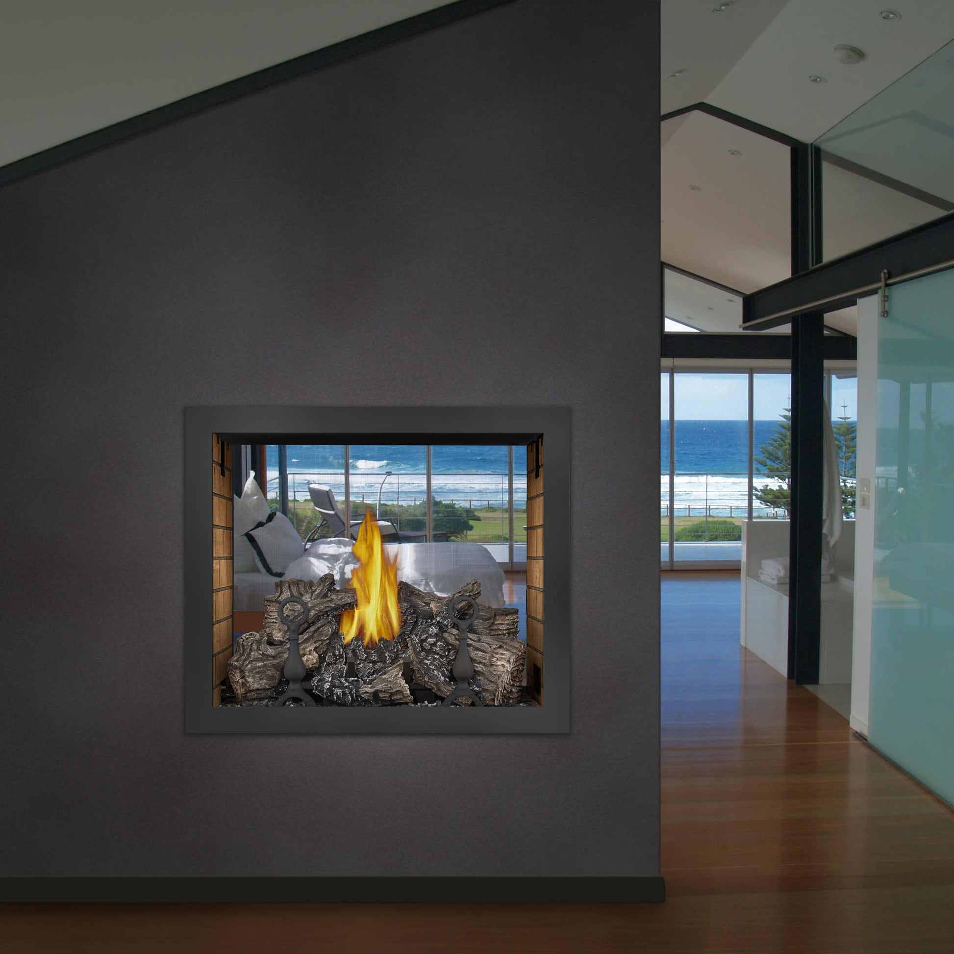 Double-sided gas fireplace in wall niche with flames over dark rocky embers